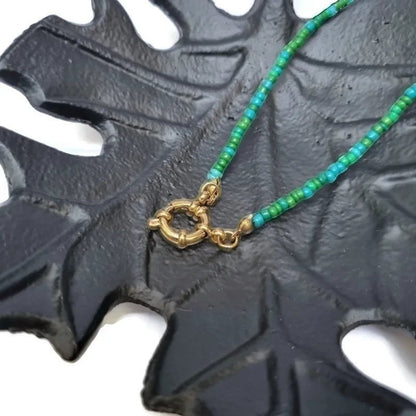 Aramat Jewels beaded necklace with blue and green rocaille beads and a gold-tone clasp.
