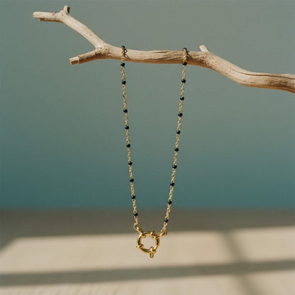 Aramat Jewels gold chain necklace with small black enamel beads and a unique gold clasp.