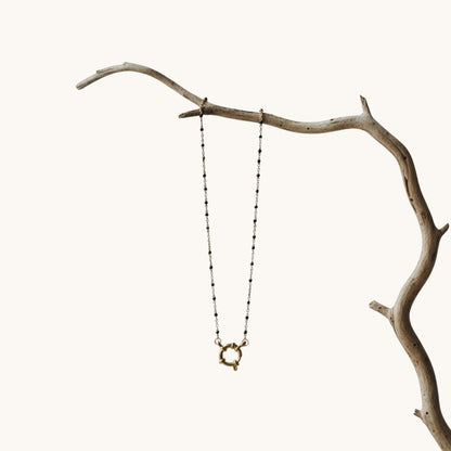 Aramat Jewels gold chain necklace with small black enamel beads and a decorative clasp.