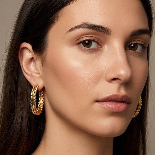 Aramat Jewels gold-tone stainless steel hoop earrings with a braided rope design, 35mm diameter.