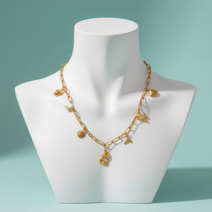 Aramat Jewels gold-tone stainless steel necklace with multiple charms including dolphins, a pearl, sun, seashell, starfish, and mermaid tail.