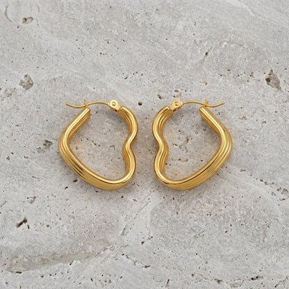 Aramat Jewels gold-tone stainless steel heart-shaped hoop earrings with triple ribbed detail.