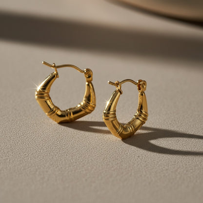Aramat Jewels small gold-colored hoop earrings with a subtle striped texture, 20mm diameter, made of stainless steel.