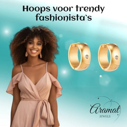 Aramat Jewels gold huggie hoop earrings with a single clear cubic zirconia stone, 13mm or 20mm diameter, 7mm wide.