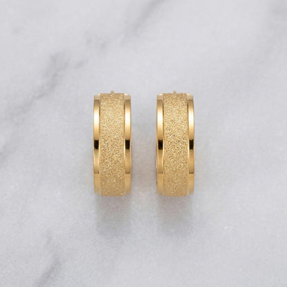 Aramat Jewels gold-tone stainless steel hoop earrings with sandblasted texture, 13mm or 20mm diameter.
