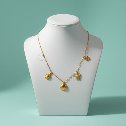 Aramat Jewels gold-tone Singapore chain necklace with shell, crab, turtle, and starfish charms.