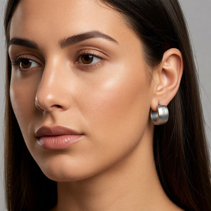 Aramat Jewels silver-coloured stainless steel hoop earrings with Greek motif, 20mm diameter, 7mm width, high gloss finish.