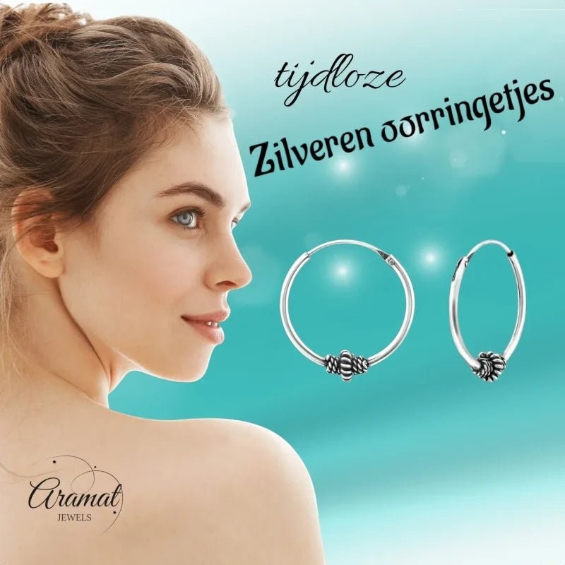 Aramat Jewels 18mm silver Bali hoop earrings with ethnic design, featuring a textured bead detail. Model shown from the side.