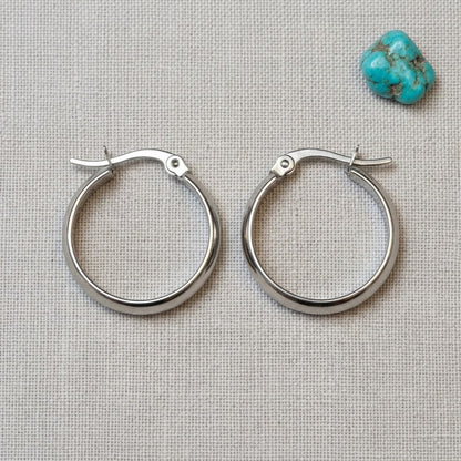 Aramat Jewels silver-tone stainless steel hoop earrings, 20mm diameter, smooth polished finish, hinged clasp.