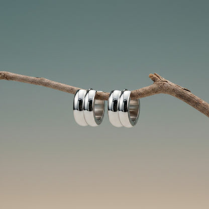Aramat Jewels silver-colored stainless steel huggie hoop earrings with two rounded stripes, 13mm diameter.