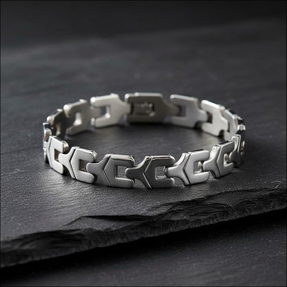 Aramat Jewels zilverkleurige edelstalen armband met fantasieschakels en subtiele steentjes op een zwarte ondergrond.