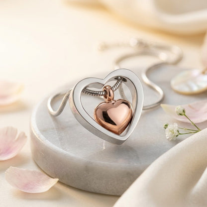 Aramat Jewels stalen hart crematiehanger in zilverkleurig en rosékleurig. Gedenksieraad met schroefsluiting voor as.