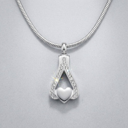 Aramat Jewels zilverkleurige ashanger in hartvorm met zirkonia steentjes, 316L edelstaal