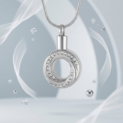 Aramat Jewels zilverkleurige RVS ashanger open cirkel met kristallen, 30x20mm, symbool van eeuwigheid.