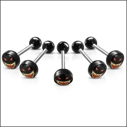 Aramat Jewels surgical steel tongue piercing with a black acrylic logo featuring a spooky face with red eyes and sharp teeth.