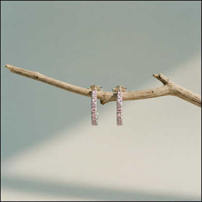 Aramat Jewels silver half hoop earrings with pink cubic zirconia stones, 14mm diameter.