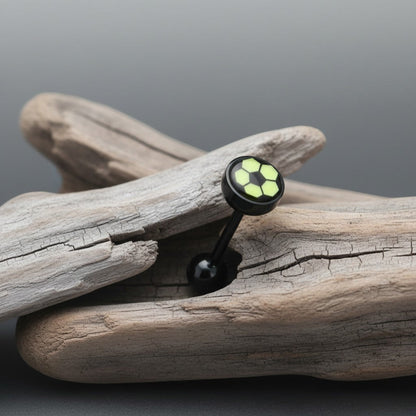Aramat Jewels black bioplast tongue piercing with a yellow soccer ball design on the top.